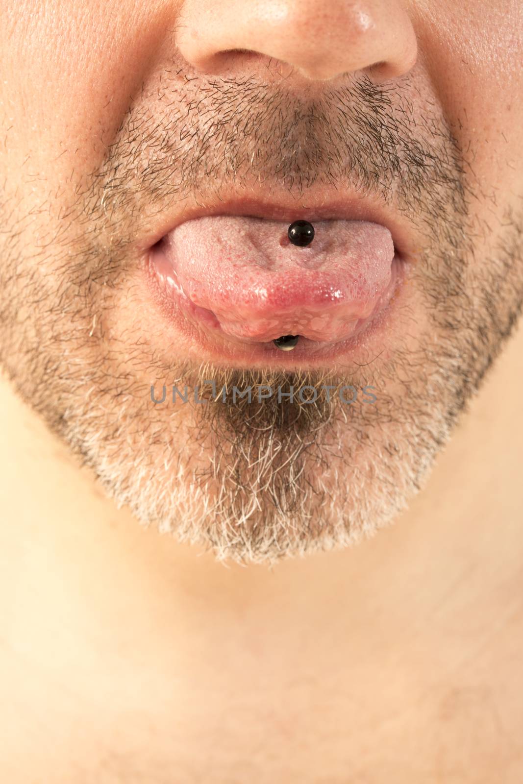 close-up of a mature man showing off his tongue ring