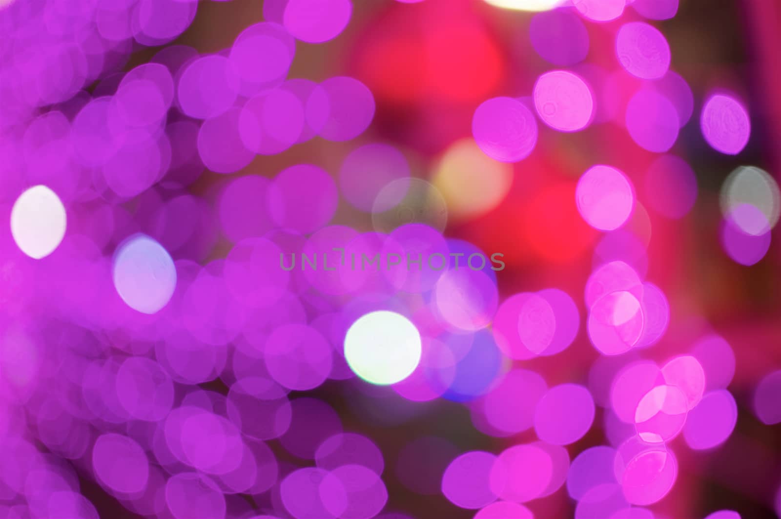 Defocused of glitter or purple and pink bokeh circle at night as background.