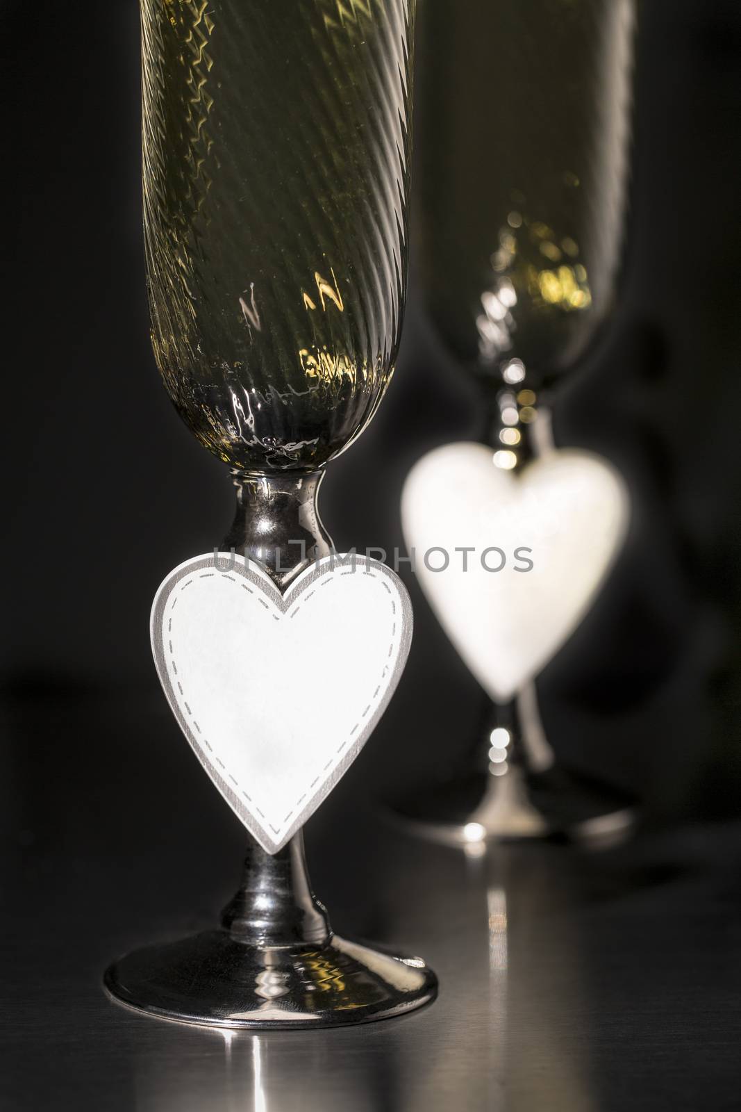 Champagne and valentines day decoration on black glitter background, love