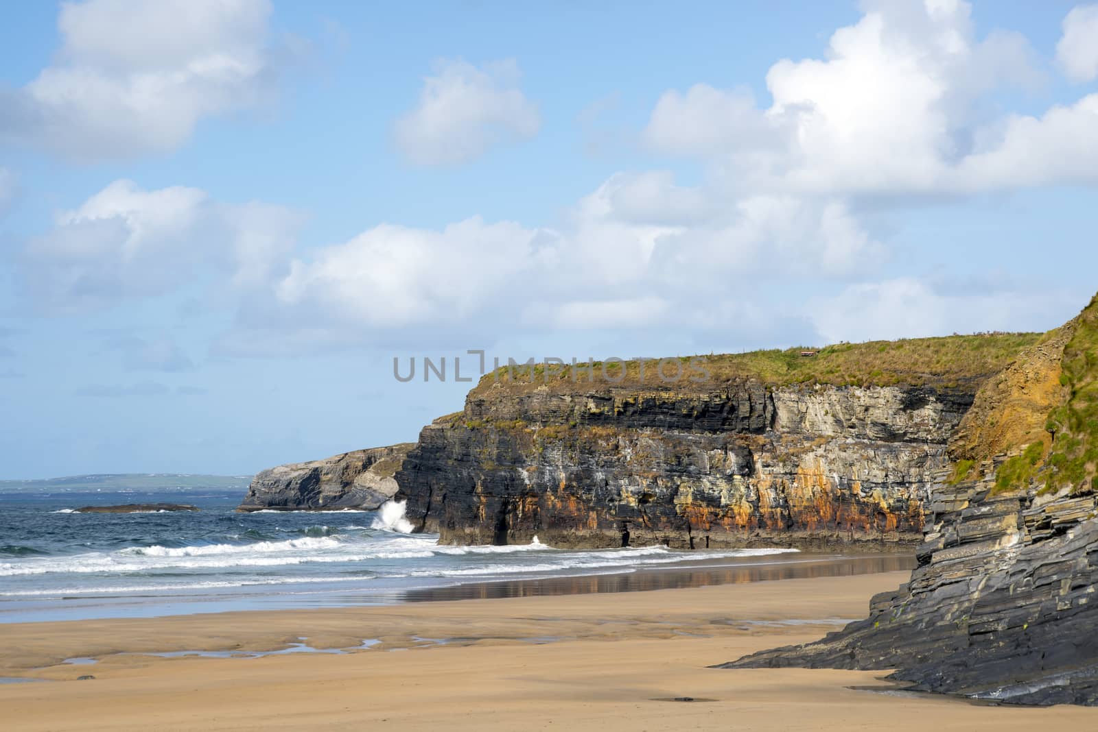 beautiful waves break on the beach by morrbyte