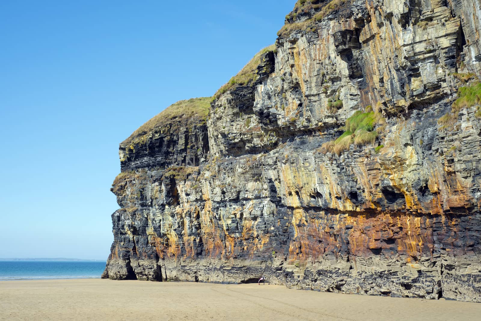 blue skies and sea at ballybunion cliffs by morrbyte