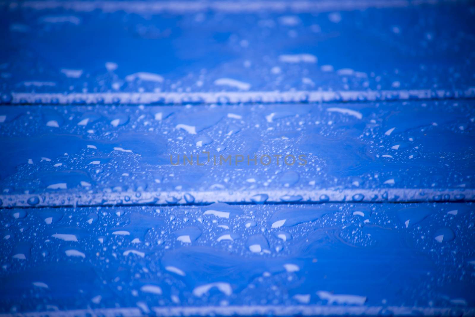 blue wooden planks with water and rain drops on the surface