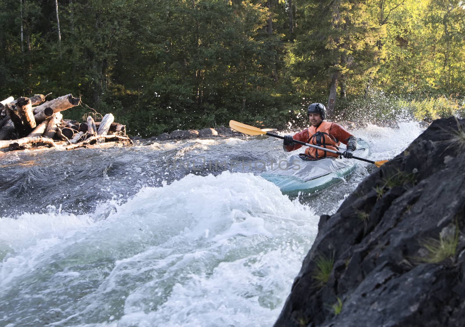 Kayaker in the  whitewater of a river Umba in Russia