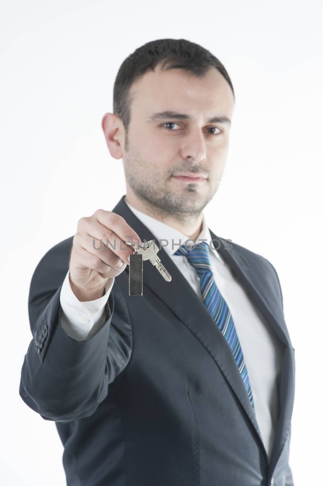 Businessman give metal home key by celaler