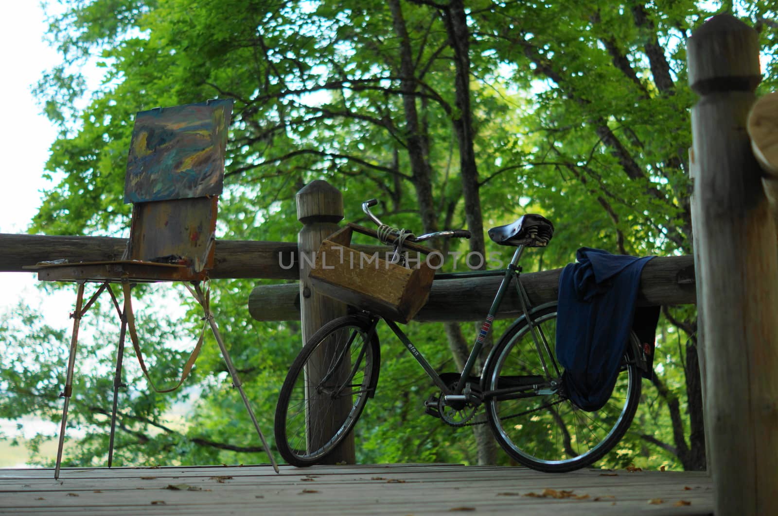 Painting canvas on tripod under tree with bicycle