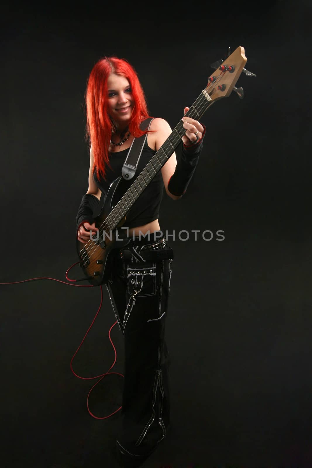 Teenage girl learning to play guitar