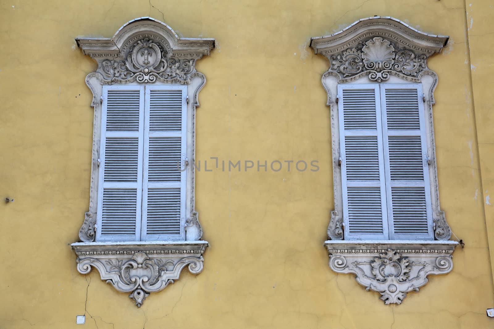 A window at a classical house in the typical regional color, "yellow of Parma"