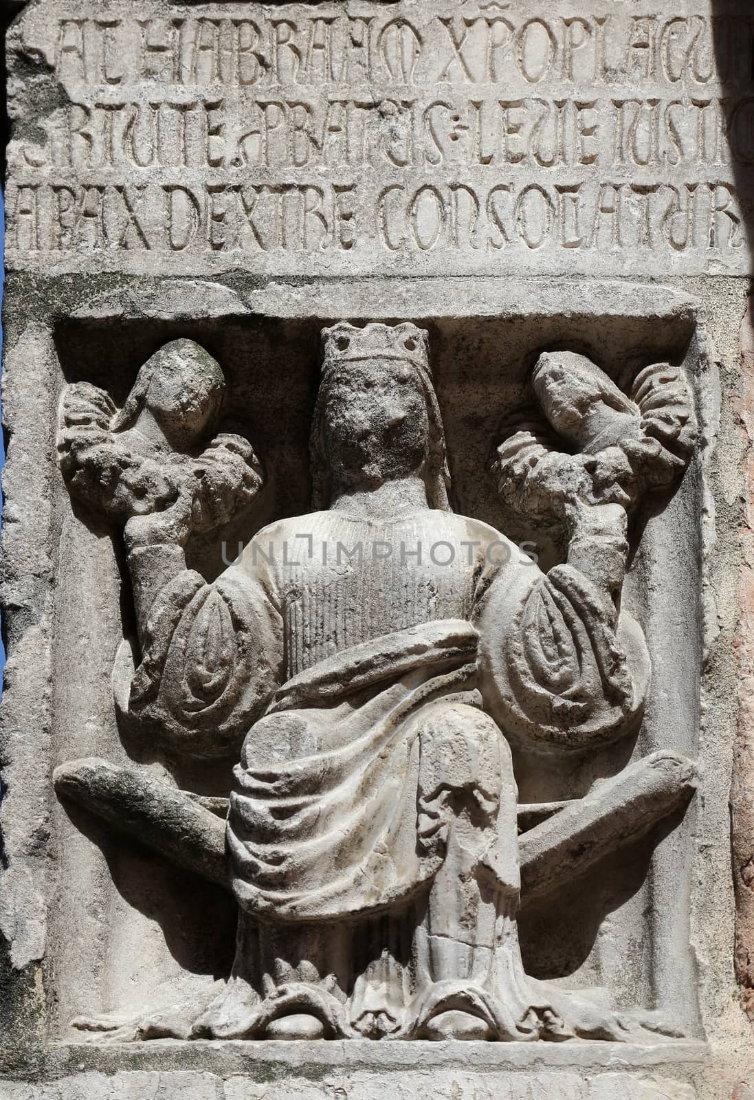Faith (holding Justice and Peace) relief at the baptistry from Parma, Emilia Romagna, Italy