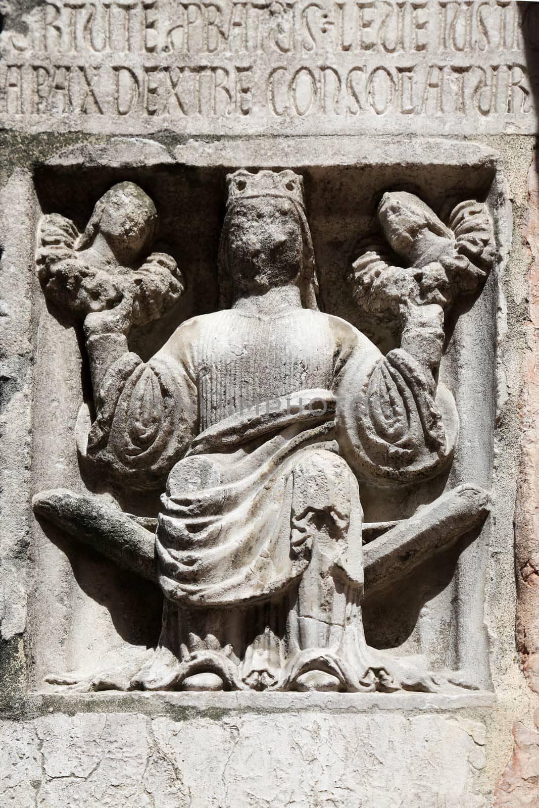 Faith (holding Justice and Peace) relief at the baptistry from Parma, Emilia Romagna, Italy