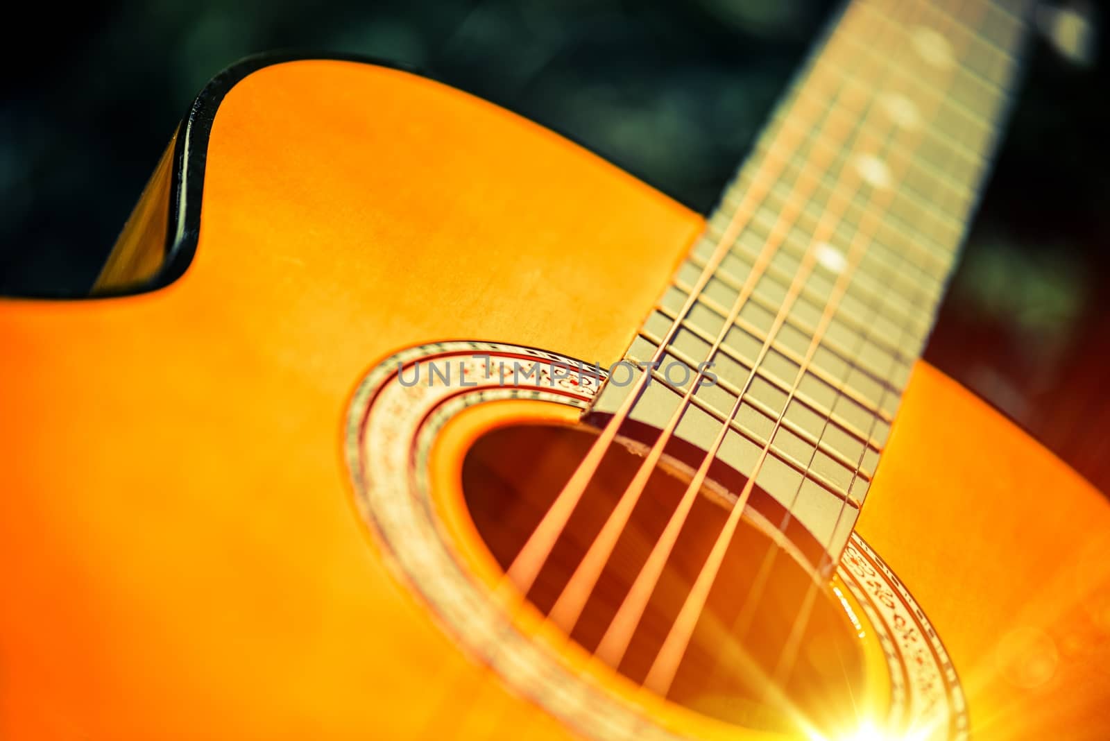 Acoustic Wooden Guitar Closeup Photo. Guitar Playing Concept.