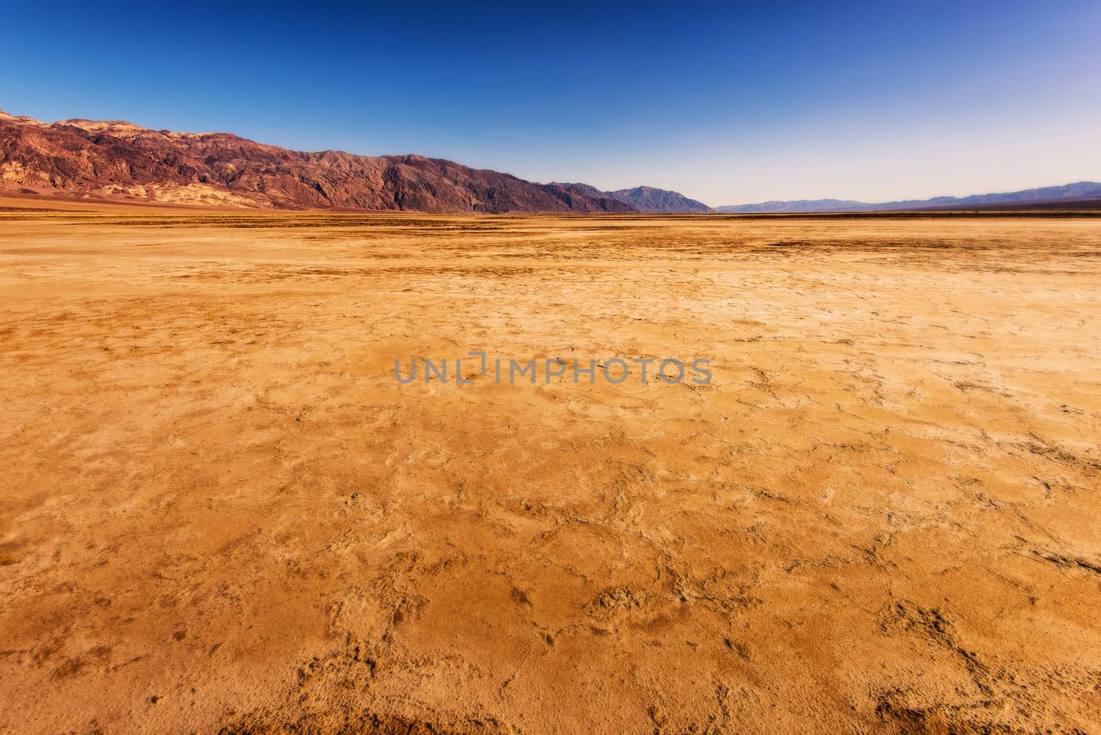Harsh Death Valley Landscape. Dry Cracked Soil in Death Valley, California, United States.