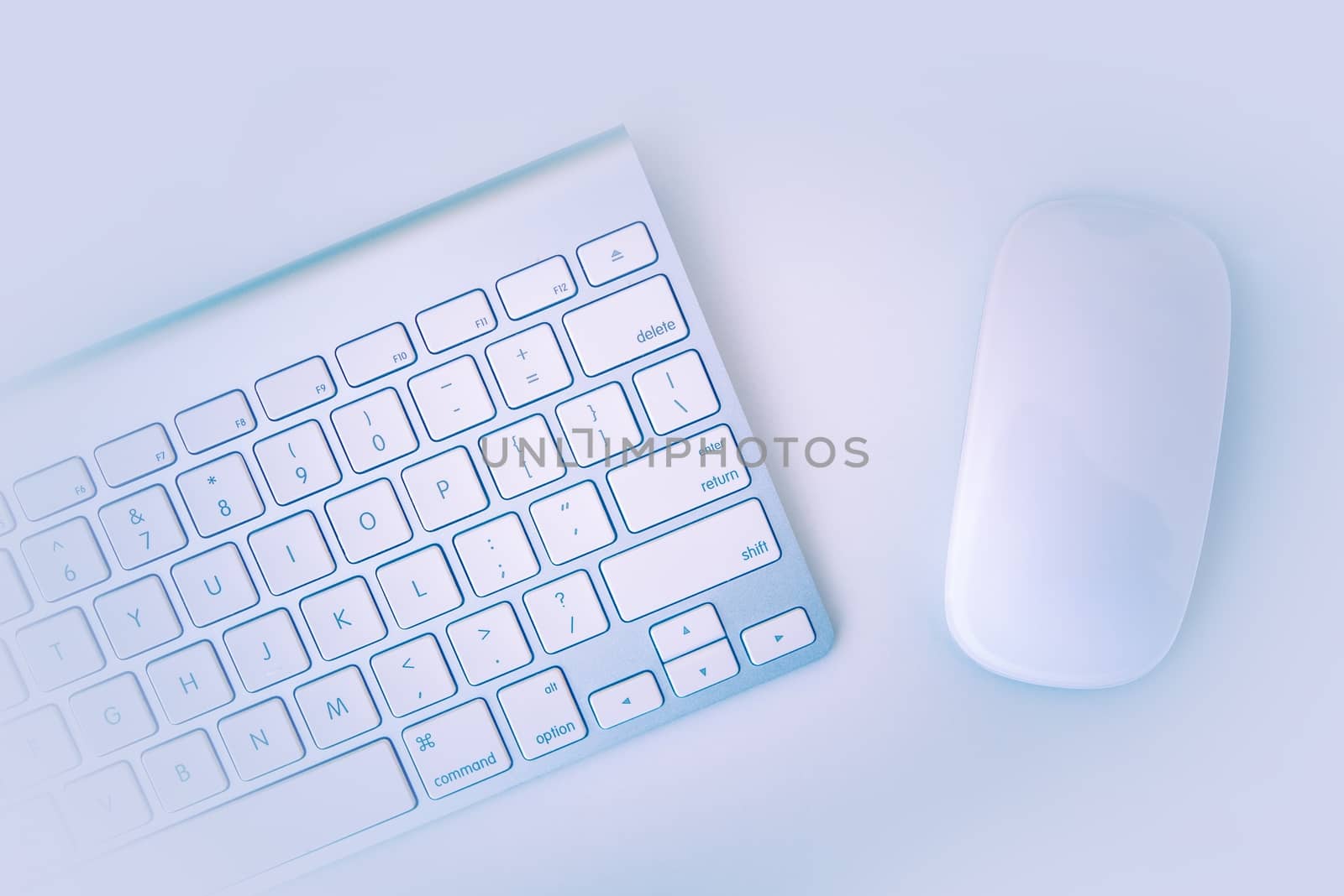 White Computer Keyboard and Mouse on the White Table. 