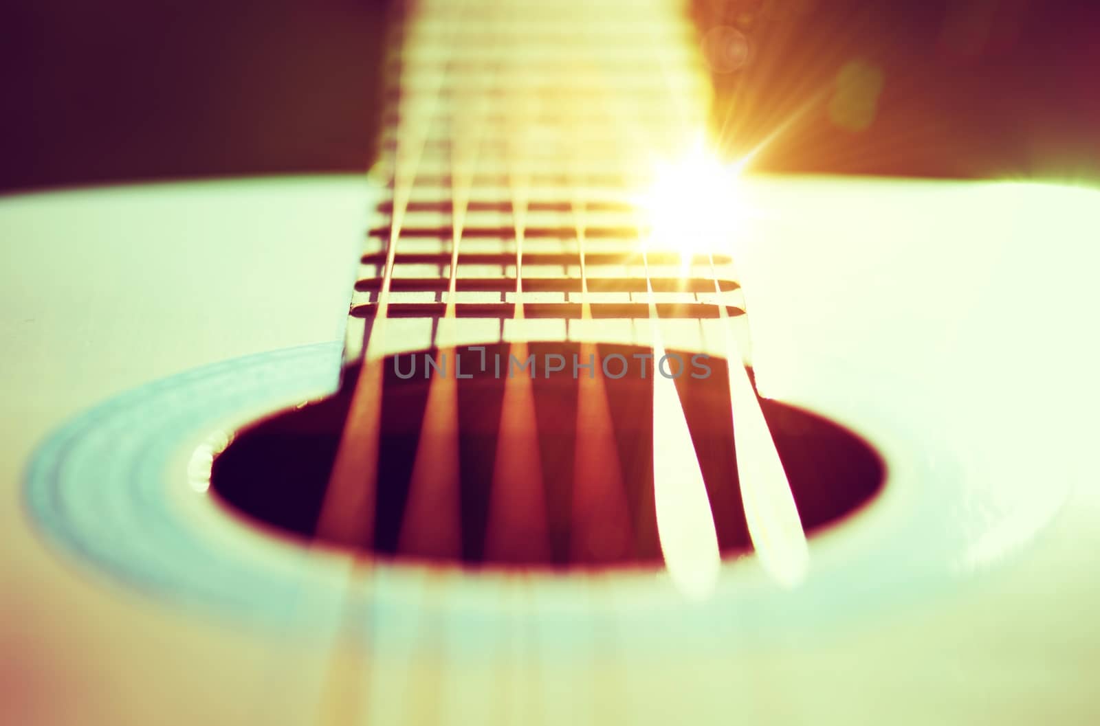 Guitar Strings Concept Photo. Guitar Playing Theme with Sun Rays Reflections.