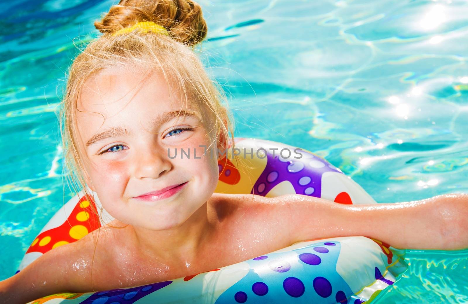 Summer Water Fun. Caucasian Girl in the Swimming Pool Learning How To Swim. Summertime Pool Time.