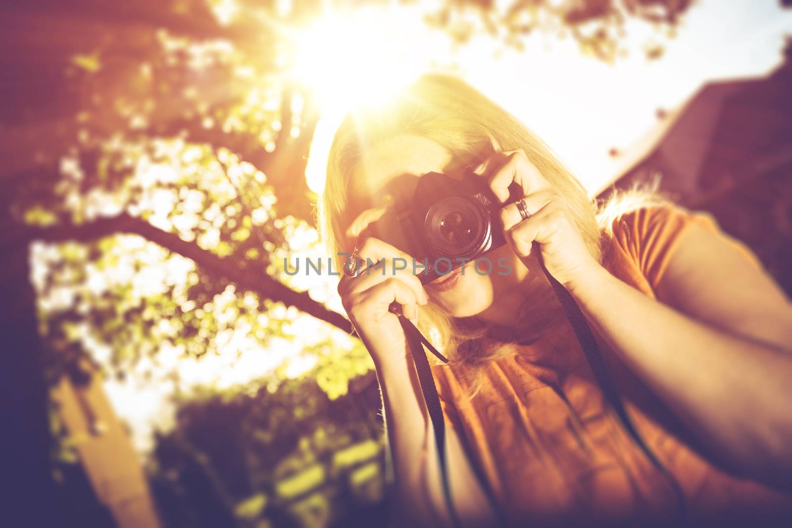 Woman with Old Camera. Woman Taking Pictures Using Vintage Camera. Summer Photography Concept.