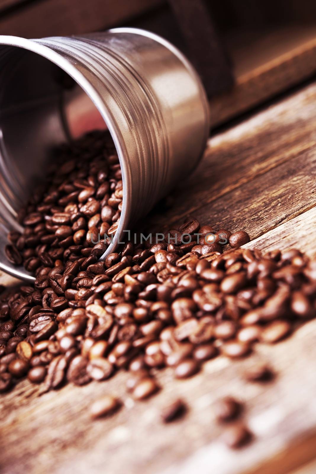 Coffee Bucket Concept. Small Metal Bucket with Coffee Beans on Aged Wood Table.