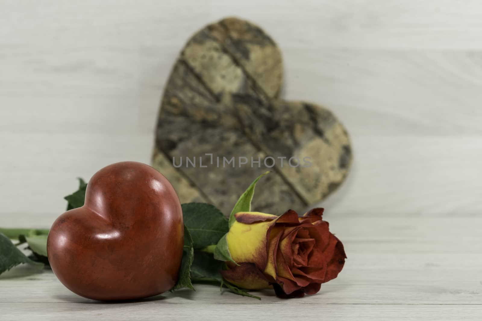 red rose with heart shape on wooden background for kothers day or valentines