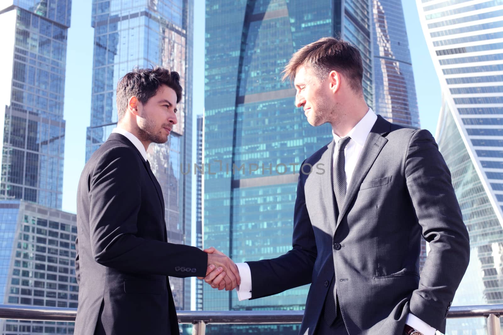 Business people shaking hands by ALotOfPeople