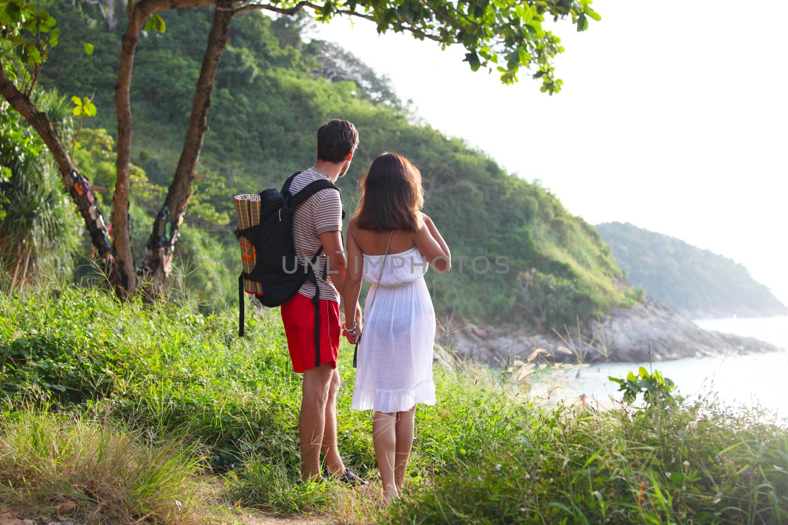 Two hikers look at sea by ALotOfPeople