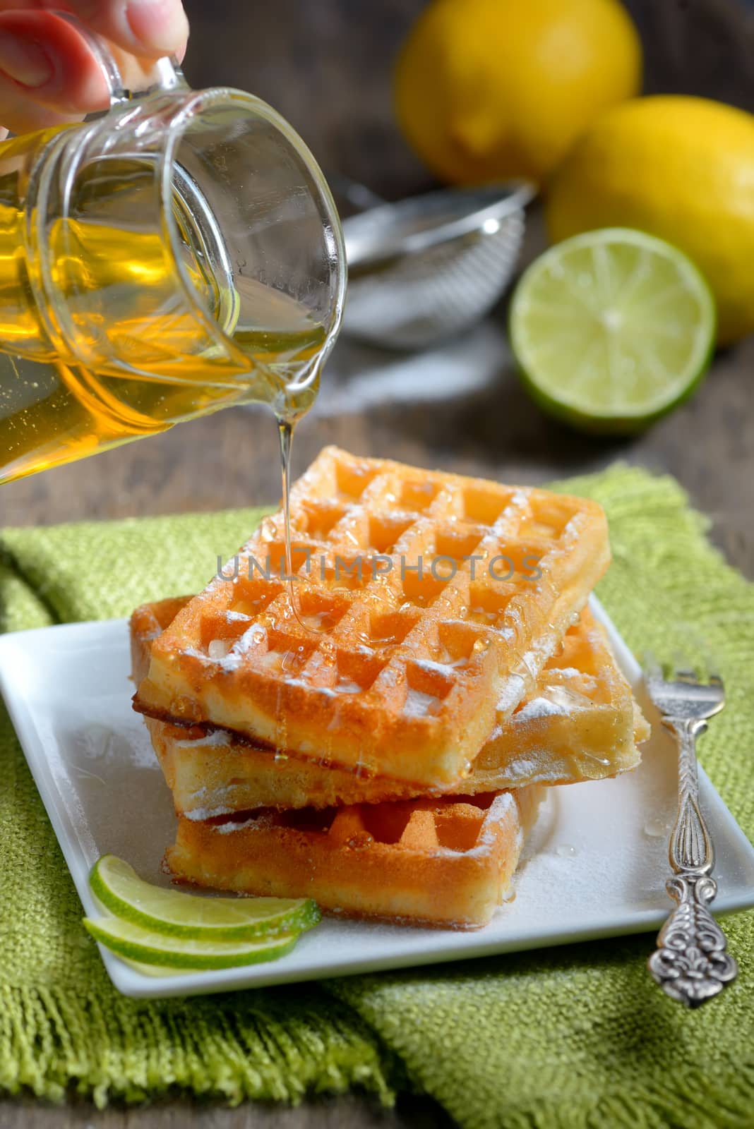 stack of waffles with honey and lemon