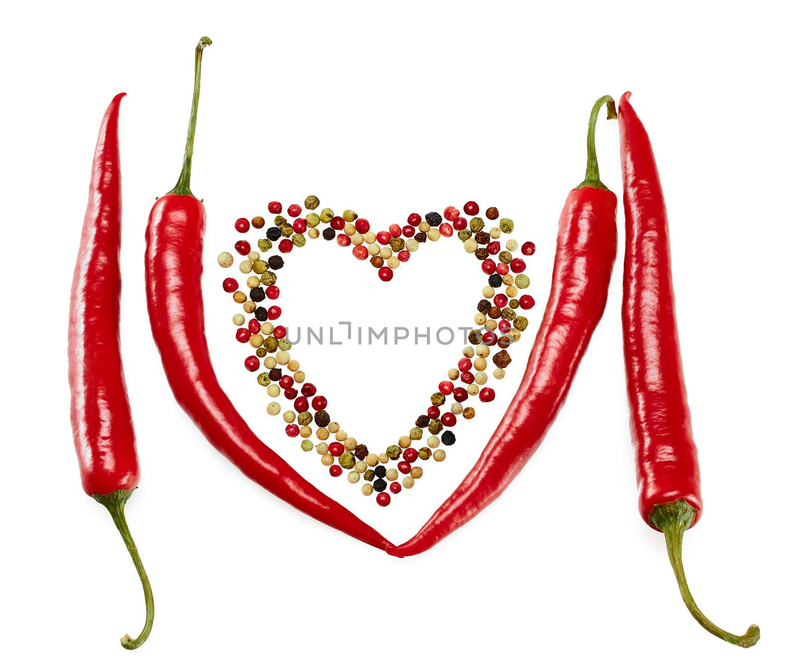 Peppers in pods, red hot and colorful mixture of peppercorns, concept of love. Multicolored peppers peas in heart shape, food closeup. Isolated on white background