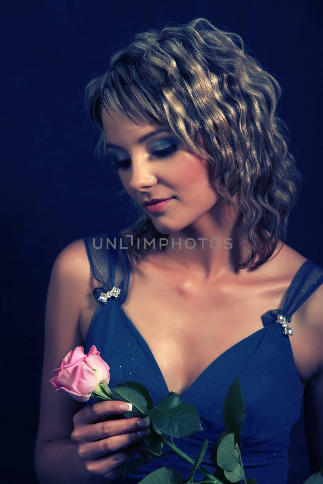 Beautiful girl smelling roses