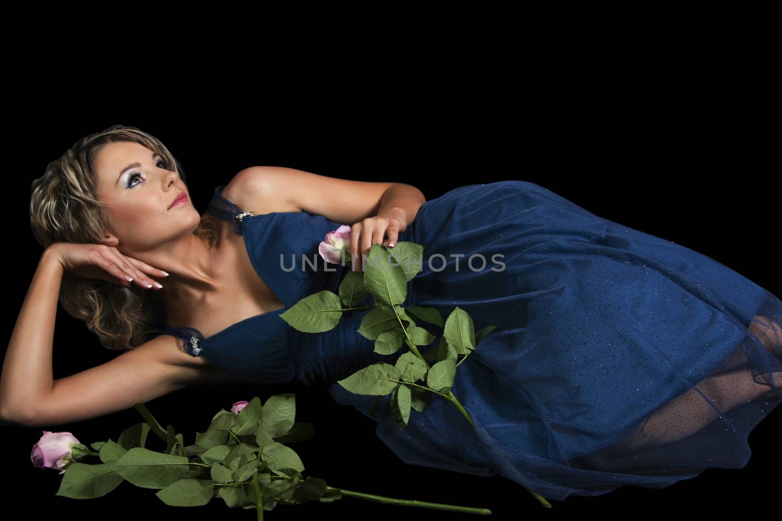 Thoughtful Young Woman With Roses Lying On Black Background