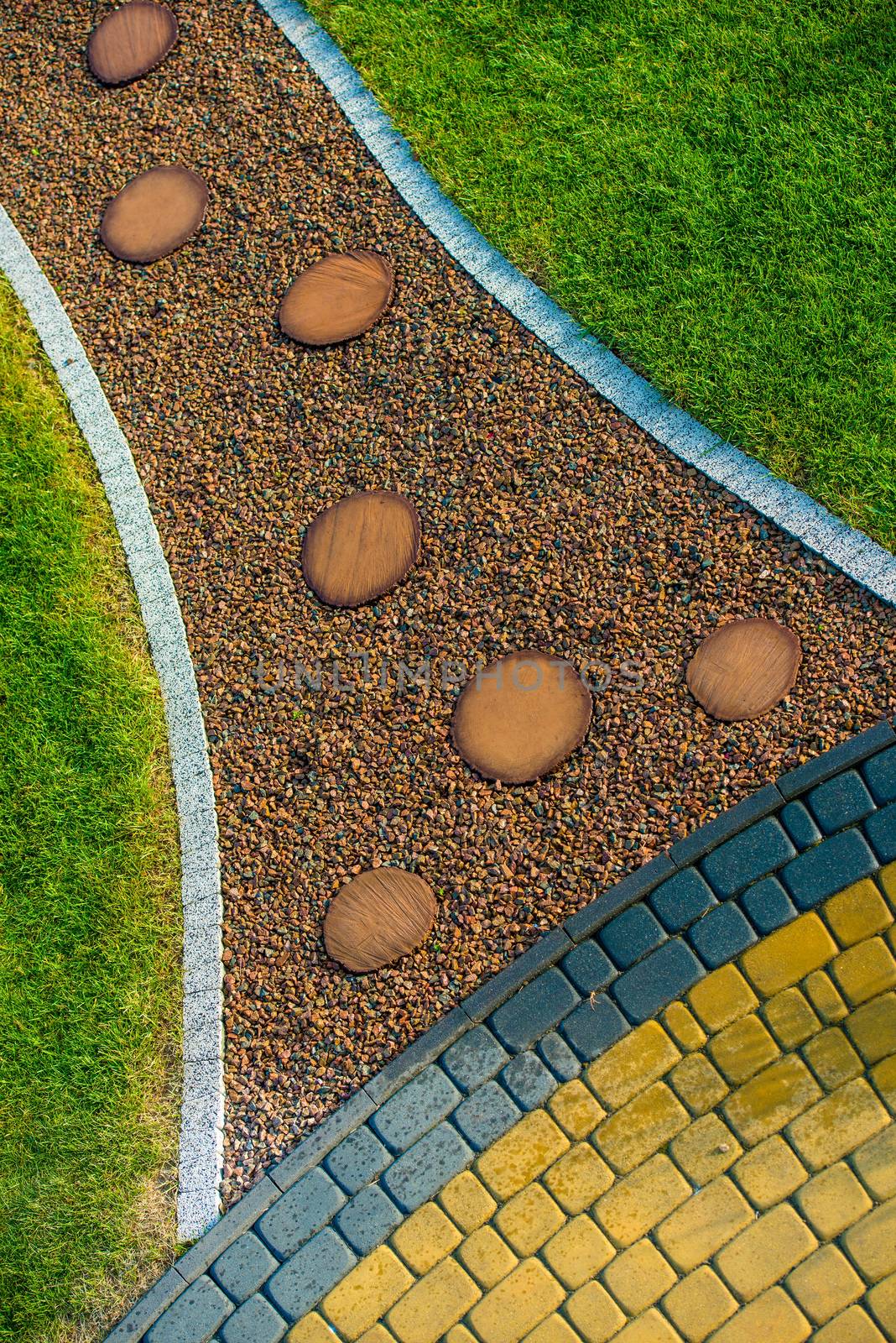 Creative Garden Pathway with Cobblestone Island Closeup Photo. Garden Design.