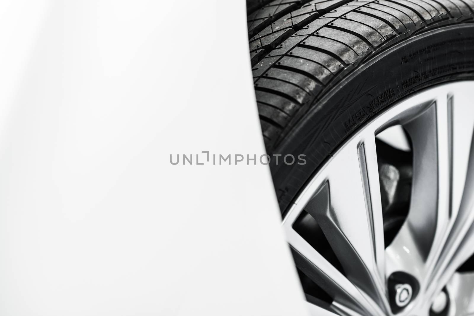 New Car Tire Closeup Photo. Modern Car Alloy Wheel.