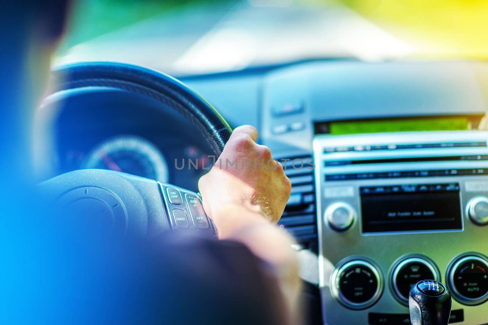 Summer Trip by Car. Driving Theme. Men Driving Car. Hand on Steering Wheel Closeup.