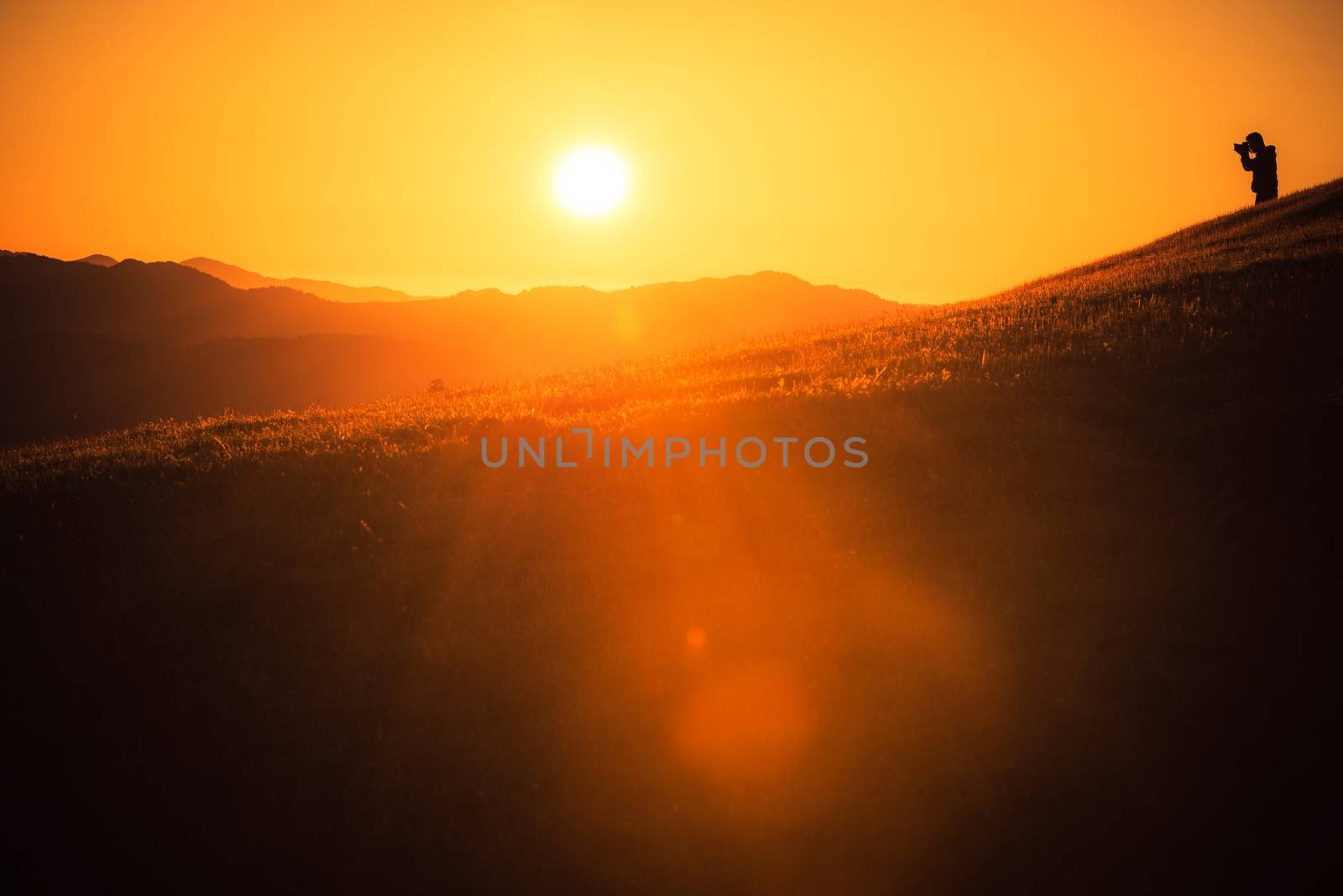 Nature and Travel Photographer on the Hill During Scenic Sunset. Northern California Landscape.