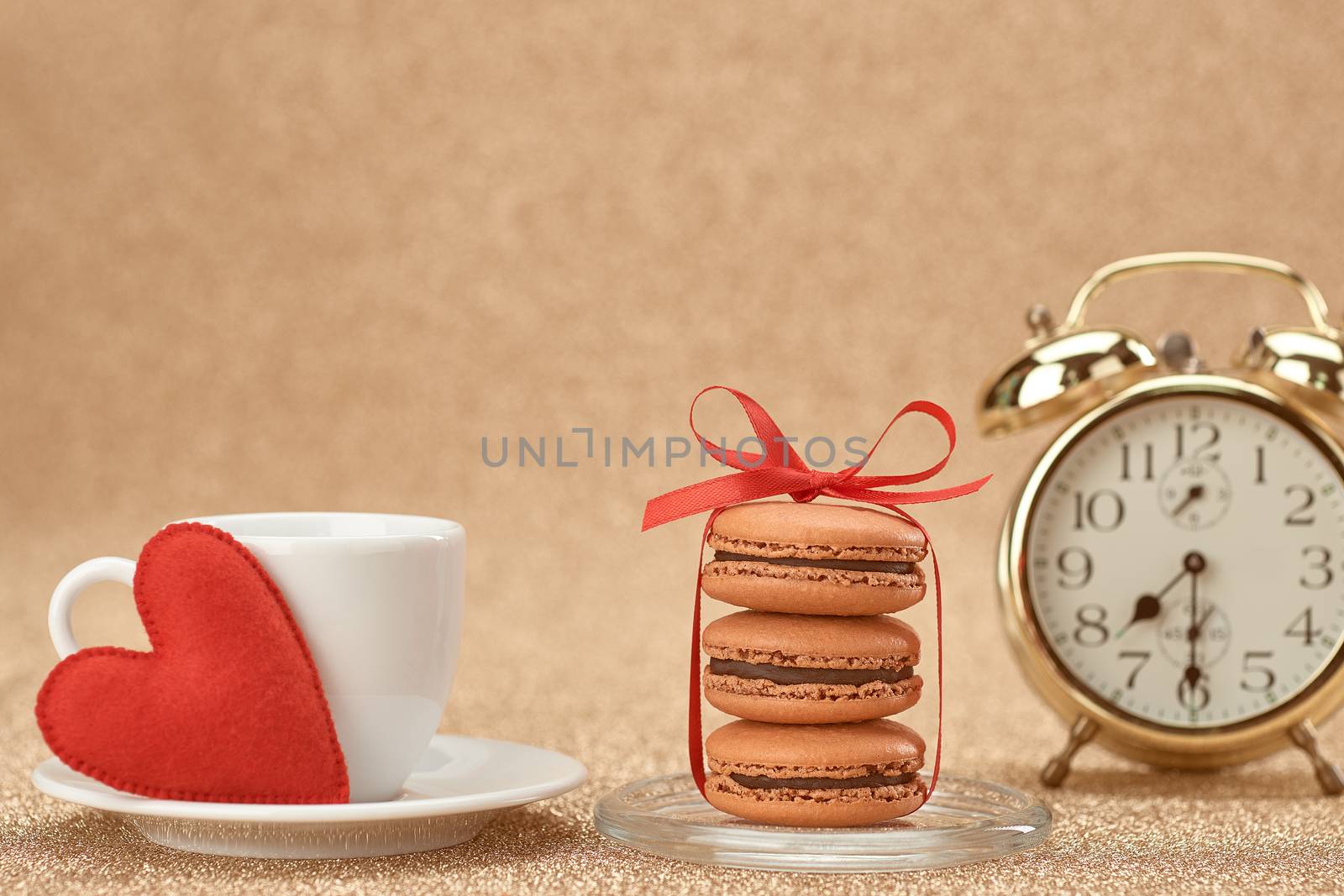 Macarons french dessert, cup of coffee.Gold alarm clock, breakfast time, red heart.Vintage retro romantic style.Unusual creative art greeting card, shiny background. Love,Valentines Day