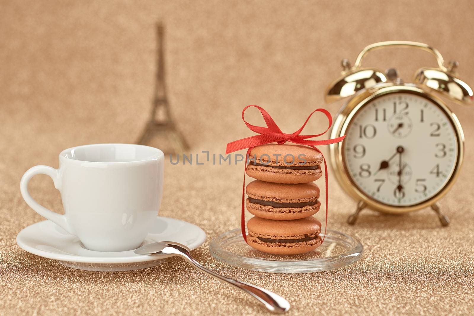 Macarons french dessert, cup of coffee.Gold alarm clock, breakfast time. Eiffel Tower, souvenir Paris. Vintage retro romantic style.Unusual creative art greeting card, shiny background,bokeh