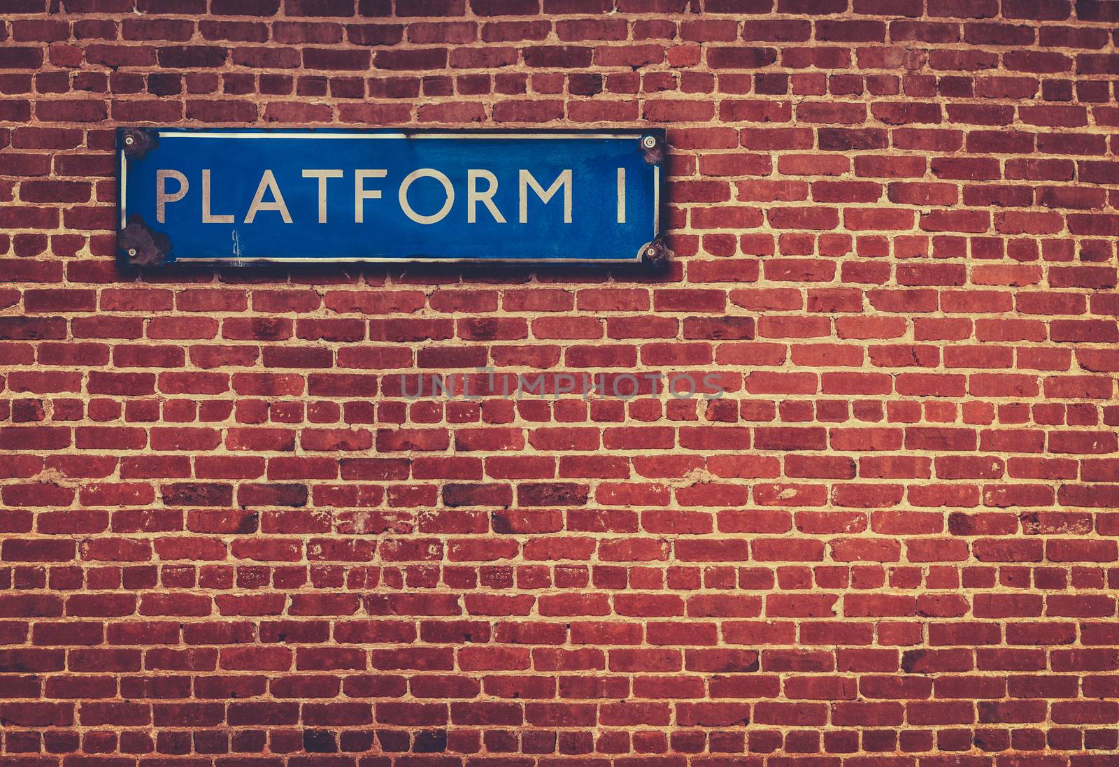 Retro British Railway Platform Sign Against A Red Brick Wall