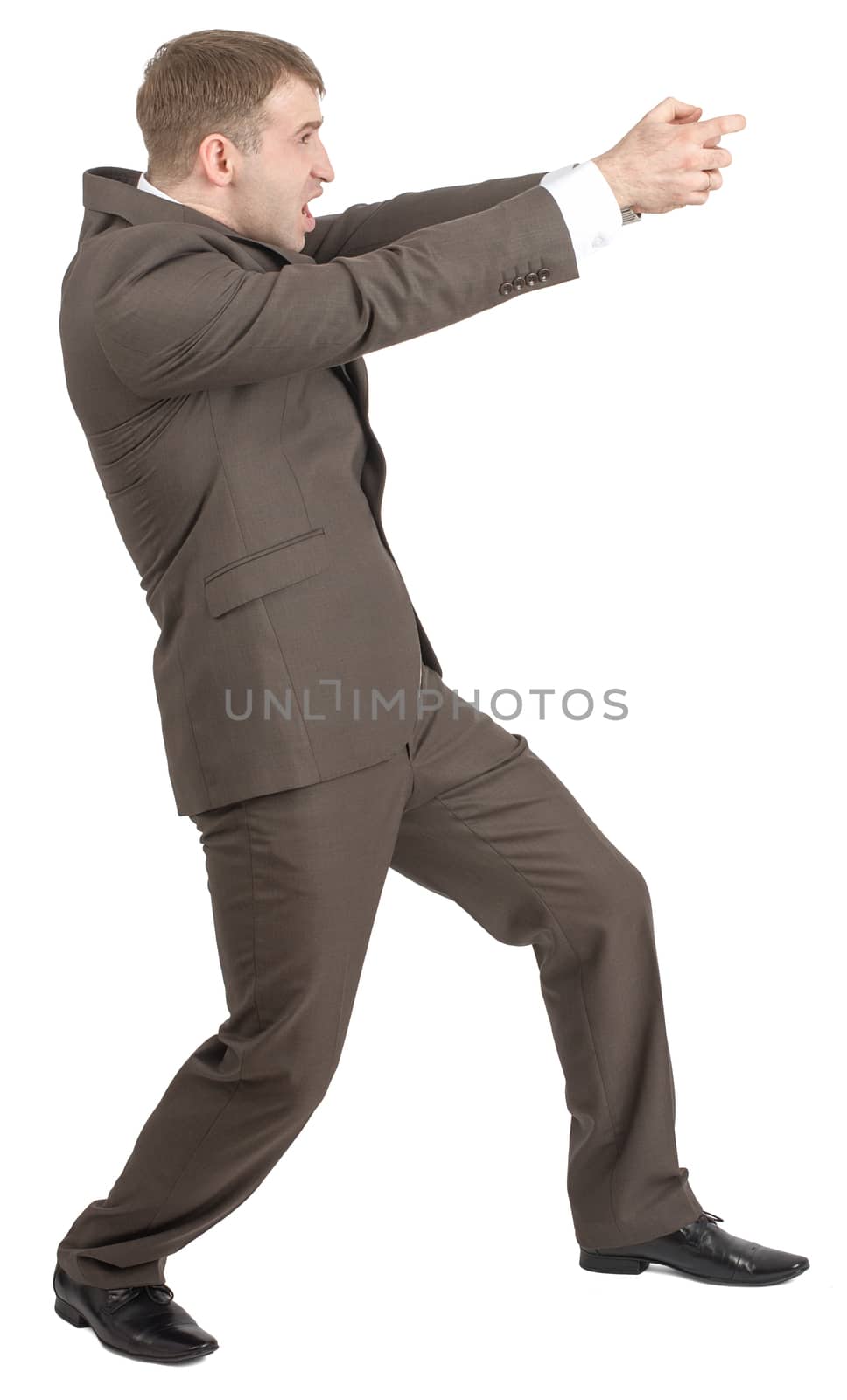 Businessman with open mouth holding invisible gun isolated on white background