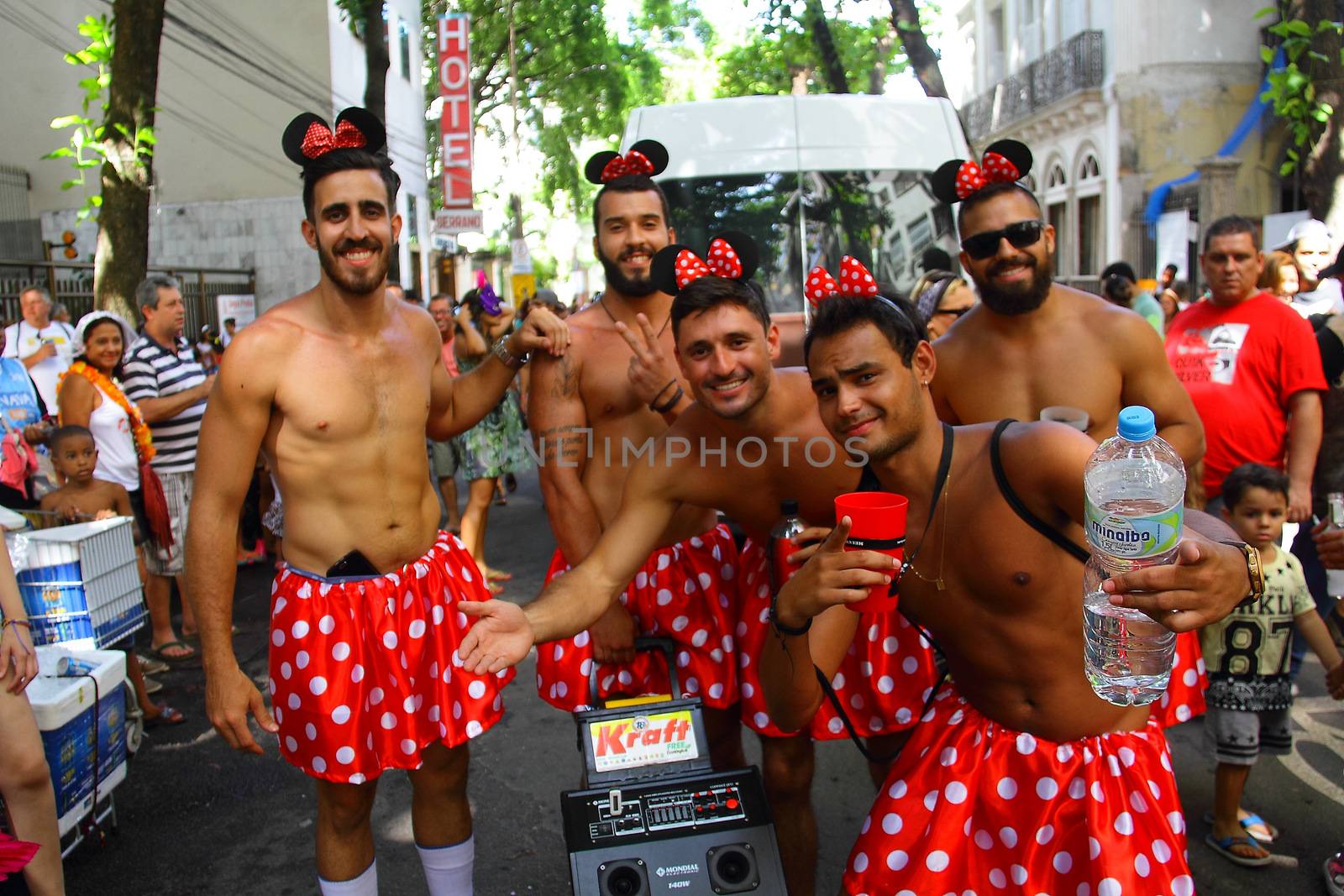 BRAZIL, Rio de Janeiro: Men dress up as Minnie Mouse as thousands of revelers take over the city on January 23, 2016 in a massive street party two weeks ahead of Carnival.  In the weeks leading up to the Carnival's official opening day on February 5, 2016, groups of people organize 'blocos', or street parties. Blocos are usually held in local neighbourhoods and feature brass bands and are much less formal than the parades.	 