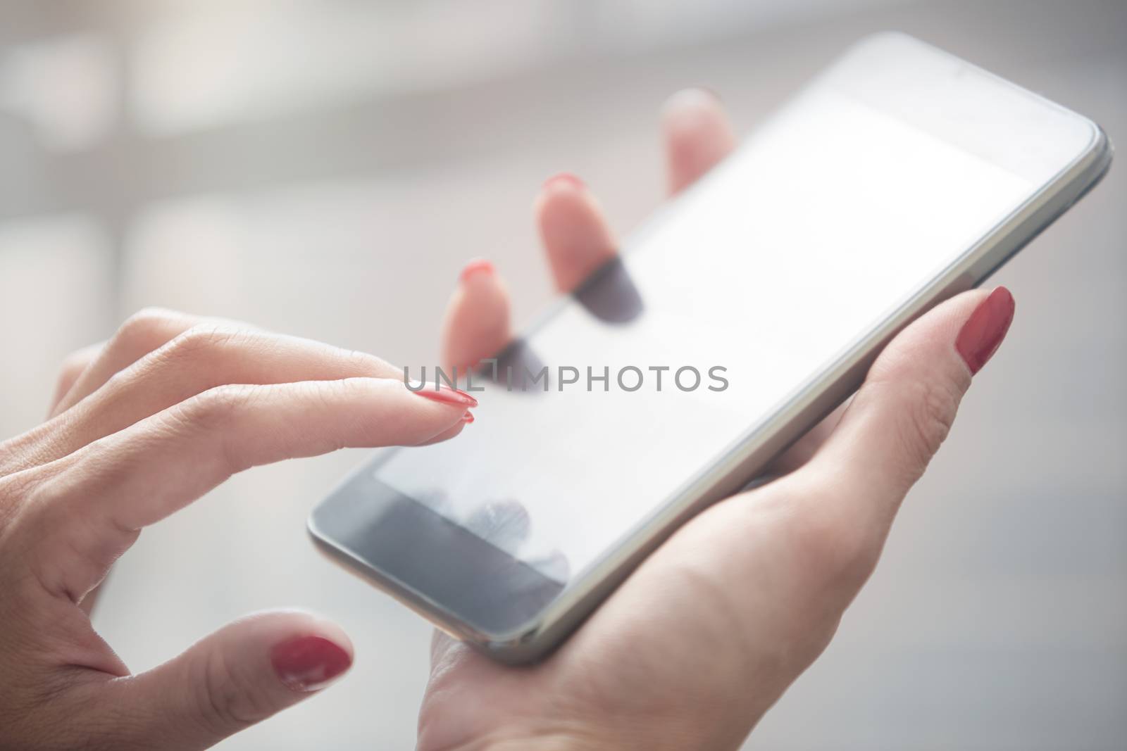 Hands of woman using smartphone