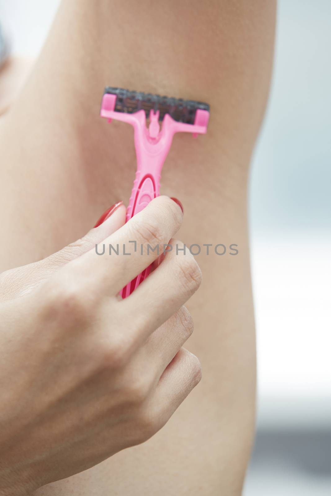 Woman shaving armpit by Novic