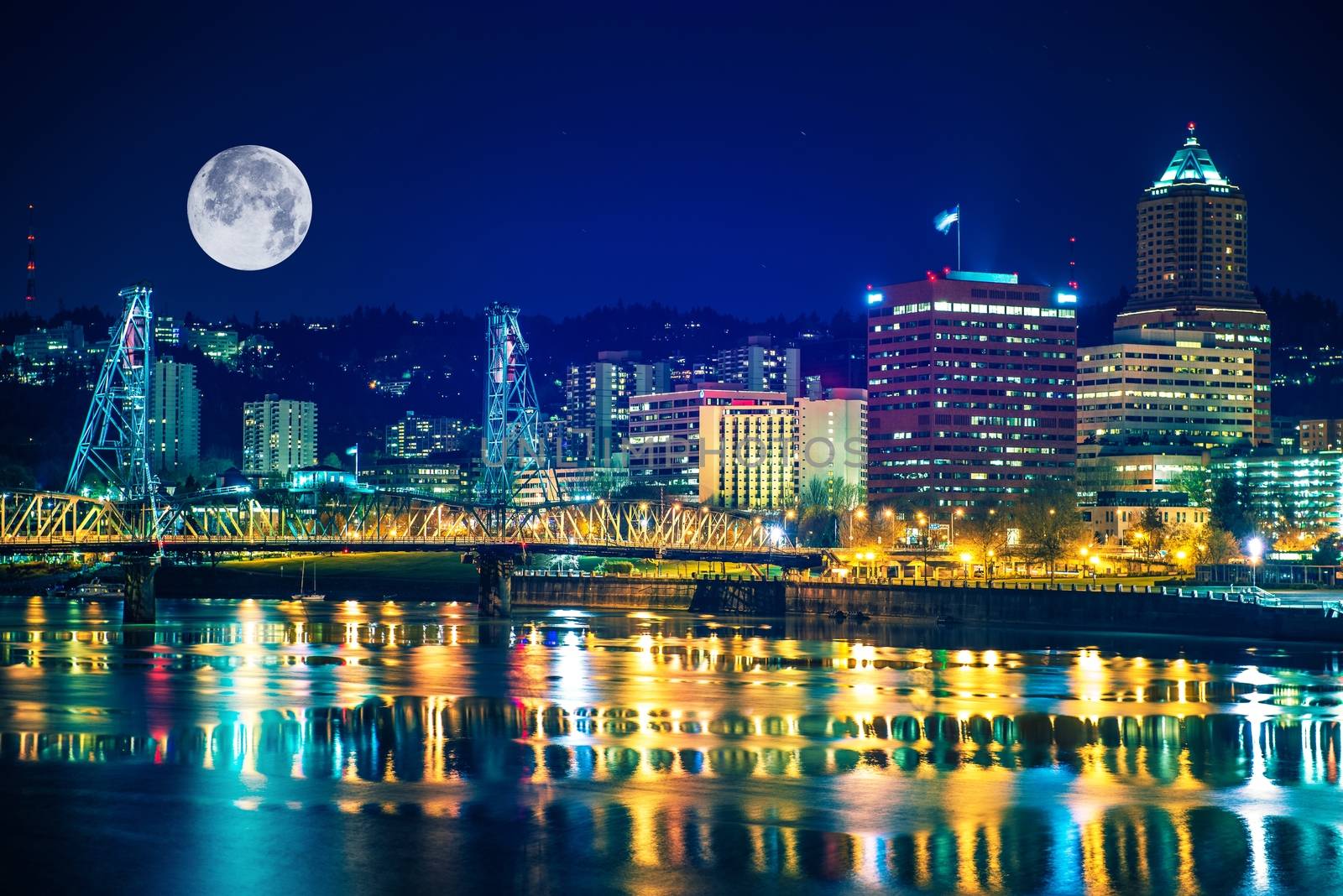 Portland Skyline with Moon and the Willamette River. Downtown Portland, Oregon, United States.