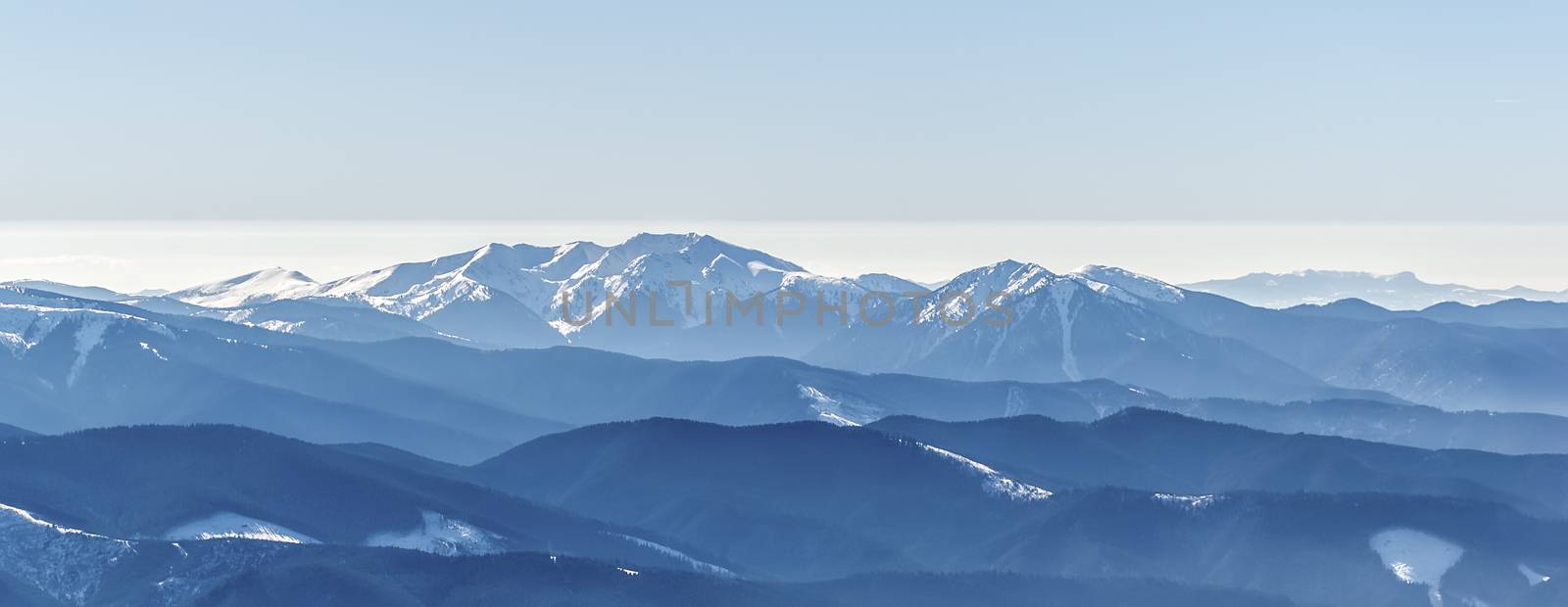 Distant sharp peaks. blue mountain ranges. Ukrainian Carpathian Mountains