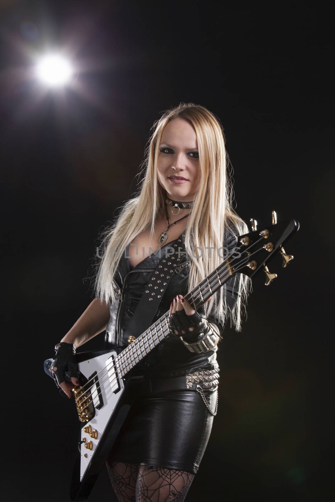 Portrait Of Young Woman Playing Guitar; Indoors