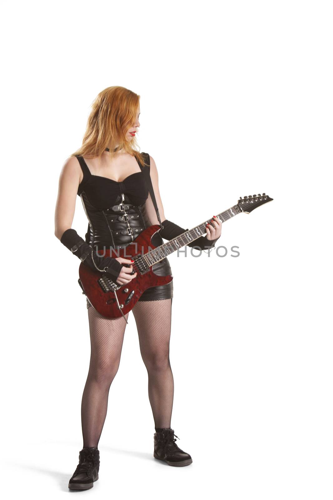 Portrait of young woman playing guitar over white background