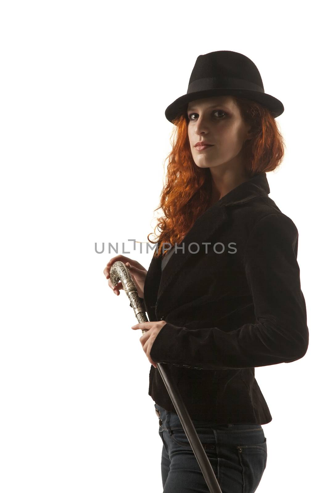 Serious red hair lady with a hat and special walking stick (contrast lightning)