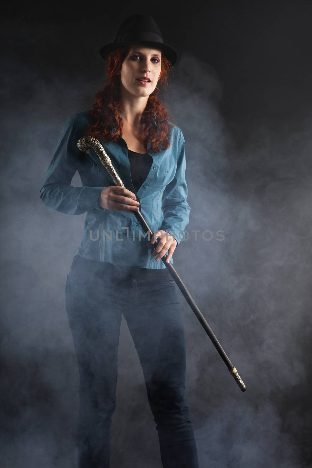 Portrait Of Female Magician Over Black Background