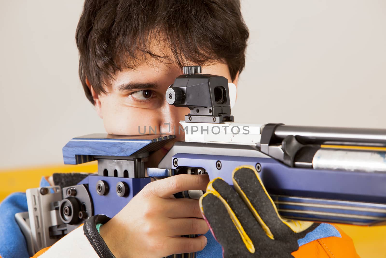 Man training sport shooting with air rifle gun