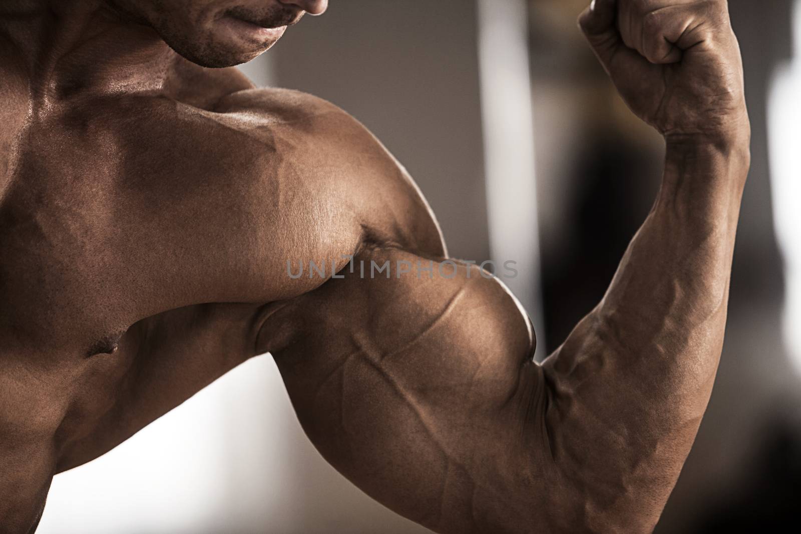 Male bodybuilder flexing his muscles