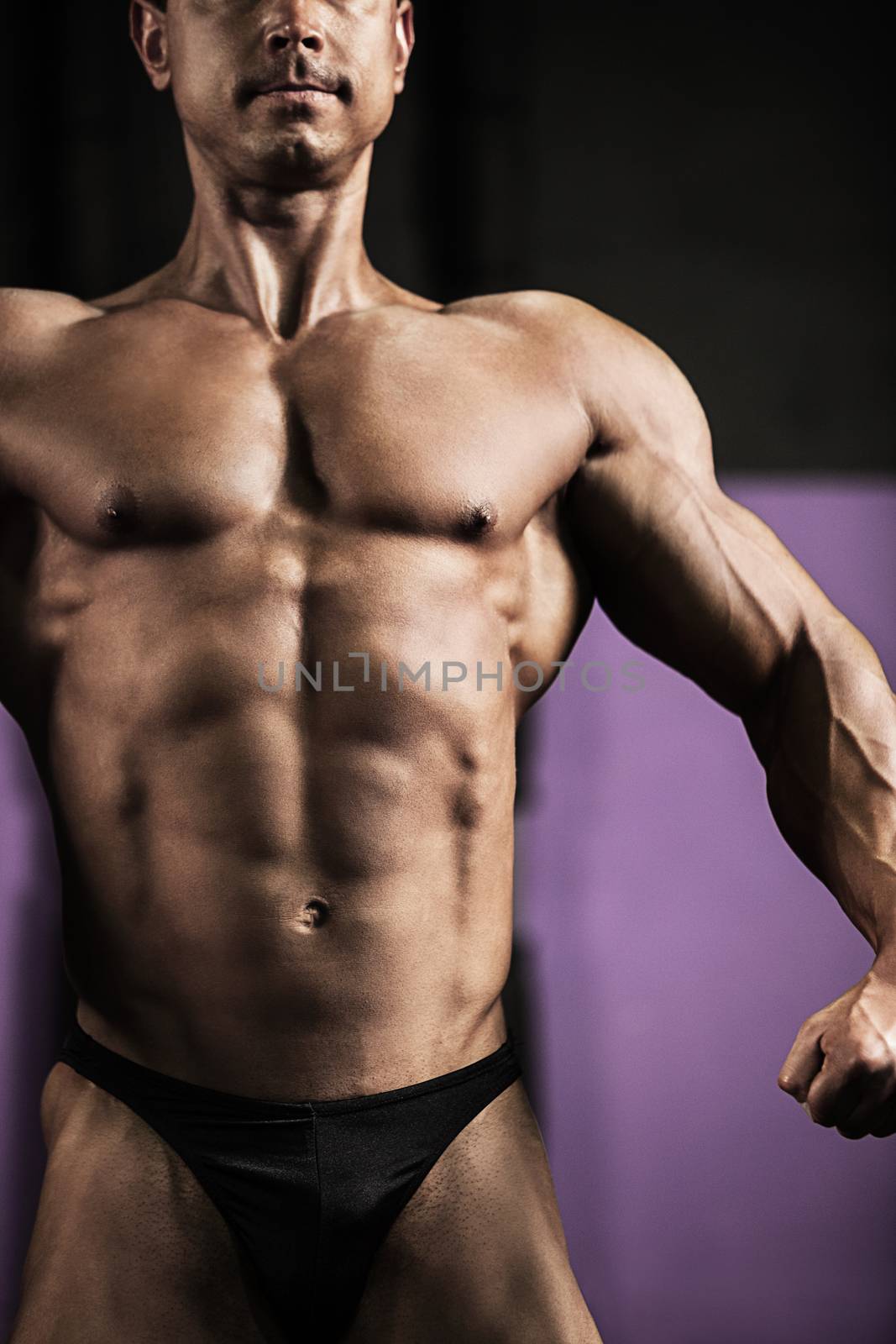 Close-up of strong athletic man posing