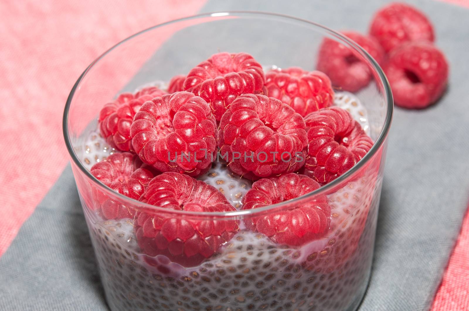 Pudding raspberries and chia seeds on a tablecloth