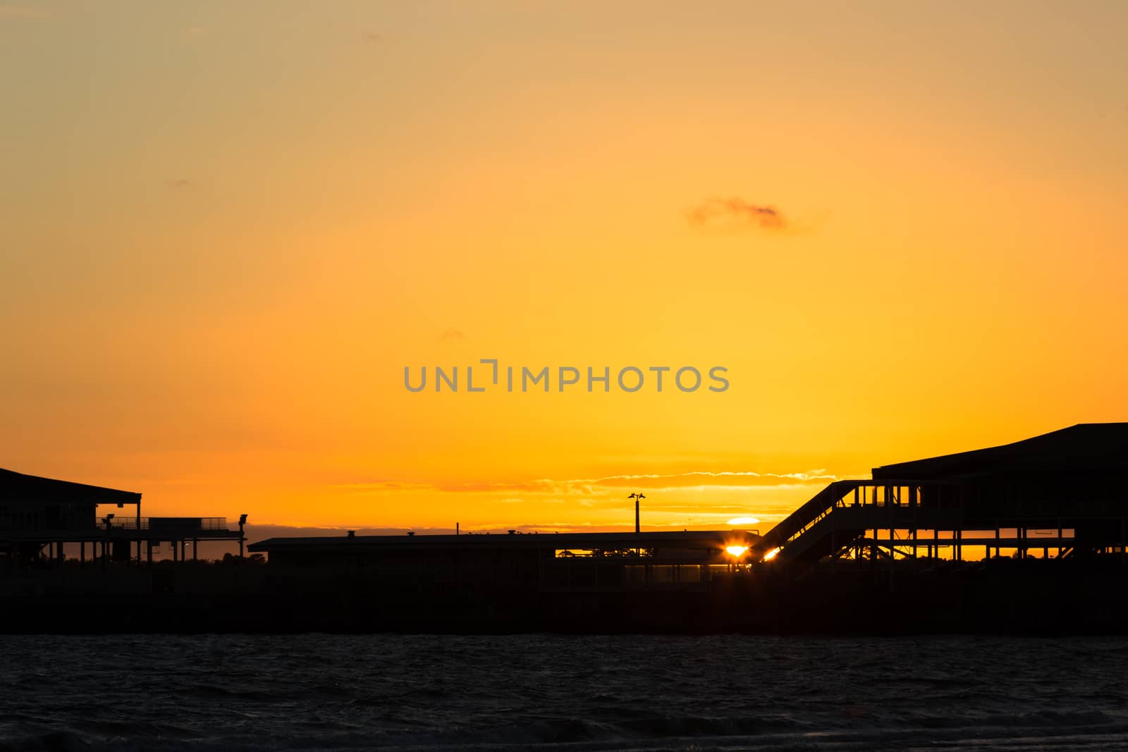 Silhouette of Station Pier in Melbourne with the sunsetting in the background.