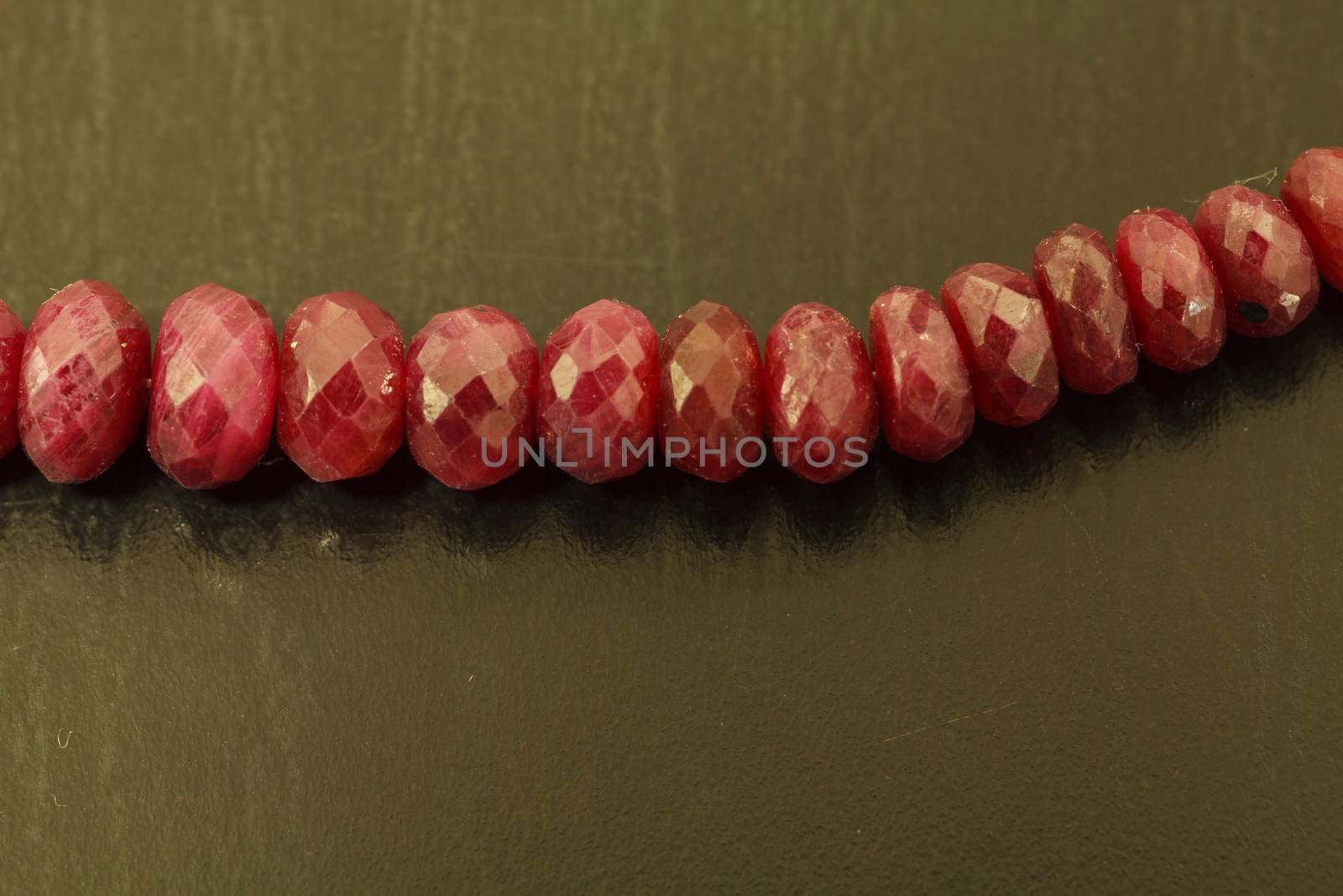 Necklace string of natural ruby bead jewelry on a black background